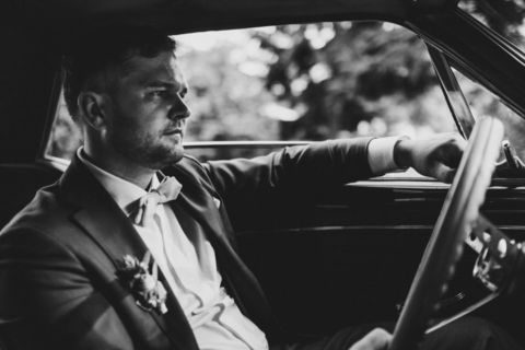 Fotoaufnahme des lässigen Bräutigams im Mustang